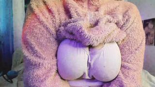 a meaty woman in a fluffy suit shows her body